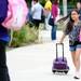 A student runs to catch up with classmates outside of Logan Elementary School on the first day of school on Tuesday, September 3, 2013. Melanie Maxwell | AnnArbor.com